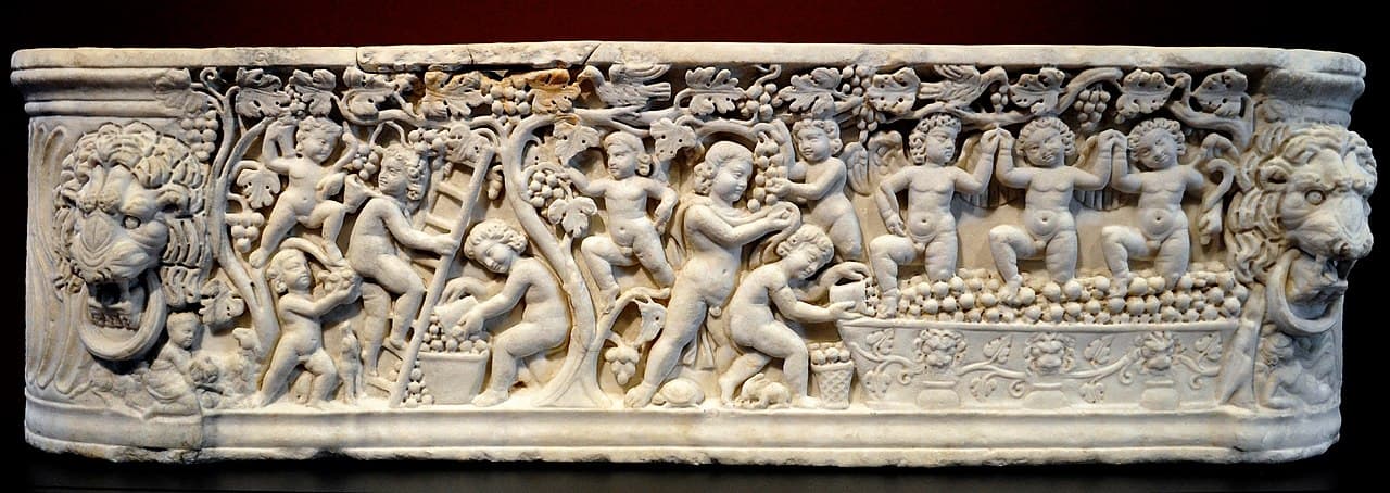 Ancient roman sarcophagus, with bas-relief sculptures of angels harvesting grapes. From the Getty Villa collection in Los Angeles.